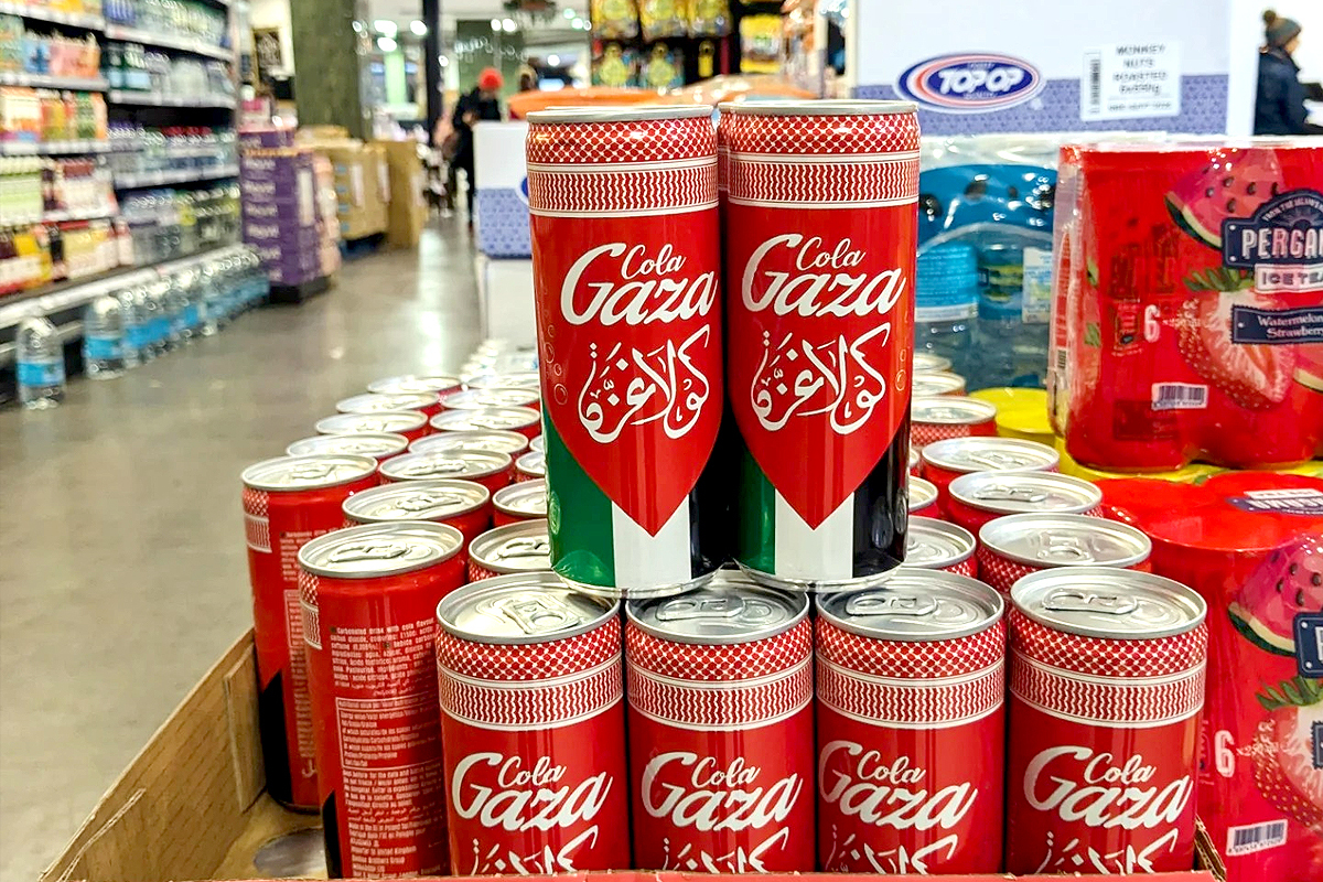 A vibrant display of Cola Gaza cans featuring their iconic red and green design, neatly arranged in a supermarket aisle, highlighting the beverage's cultural significance and availability in retail stores.