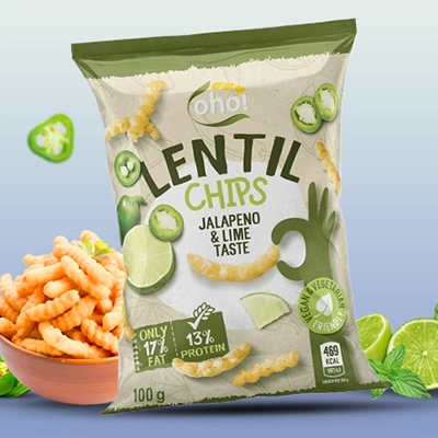 Bag of Lentil Chips Jalapeño and Lime Taste with a bowl of chips, lime slices, and jalapeño pieces.