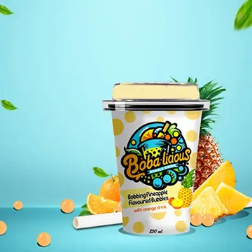 Bobbing Pineapple Flavoured Bubbles with orange drink, displayed with juicy pineapple slices.