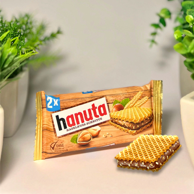 Hanuta hazelnut wafer snacks in rustic packaging, presented with a stylish and natural backdrop