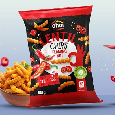 Bag of Lentil Chips Flaming Hot flavor displayed with a bowl of chips and spicy chili peppers.