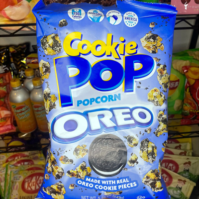 Bag of Cookie Pop Popcorn Oreo featuring popcorn coated with real Oreo cookie pieces.
