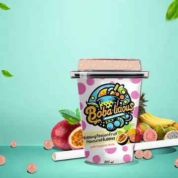 Bobbing Passion Fruit Flavoured Bubbles with tropical drink, surrounded by fresh tropical fruits in a refreshing setting.