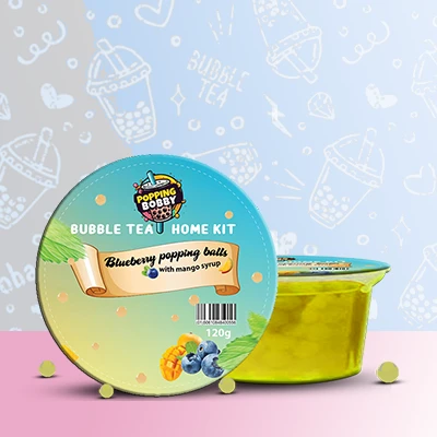Popping Bobby Bubble Tea Home Kit with Blueberry Popping Balls and Mango Syrup for a flavorful DIY drink.