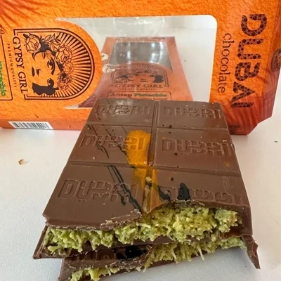 Gypsy Girl Dubai chocolate bar with Antep pistachio filling, featuring rich layers of chocolate and a premium orange packaging.