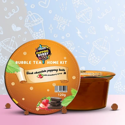 Popping Bobby Bubble Tea Home Kit with Dark Chocolate Popping Balls and Strawberry Syrup for a delightful DIY bubble tea experience.